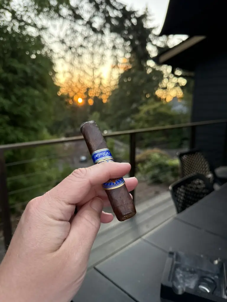 An E.P. Carrillo Pledge held over the deck rail, the sun going down through the trees behind it