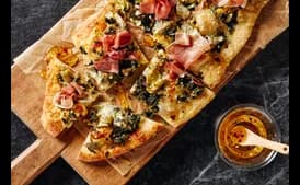 Artichoke, Spinach, and Prosciutto Flatbreads With Spicy Honey