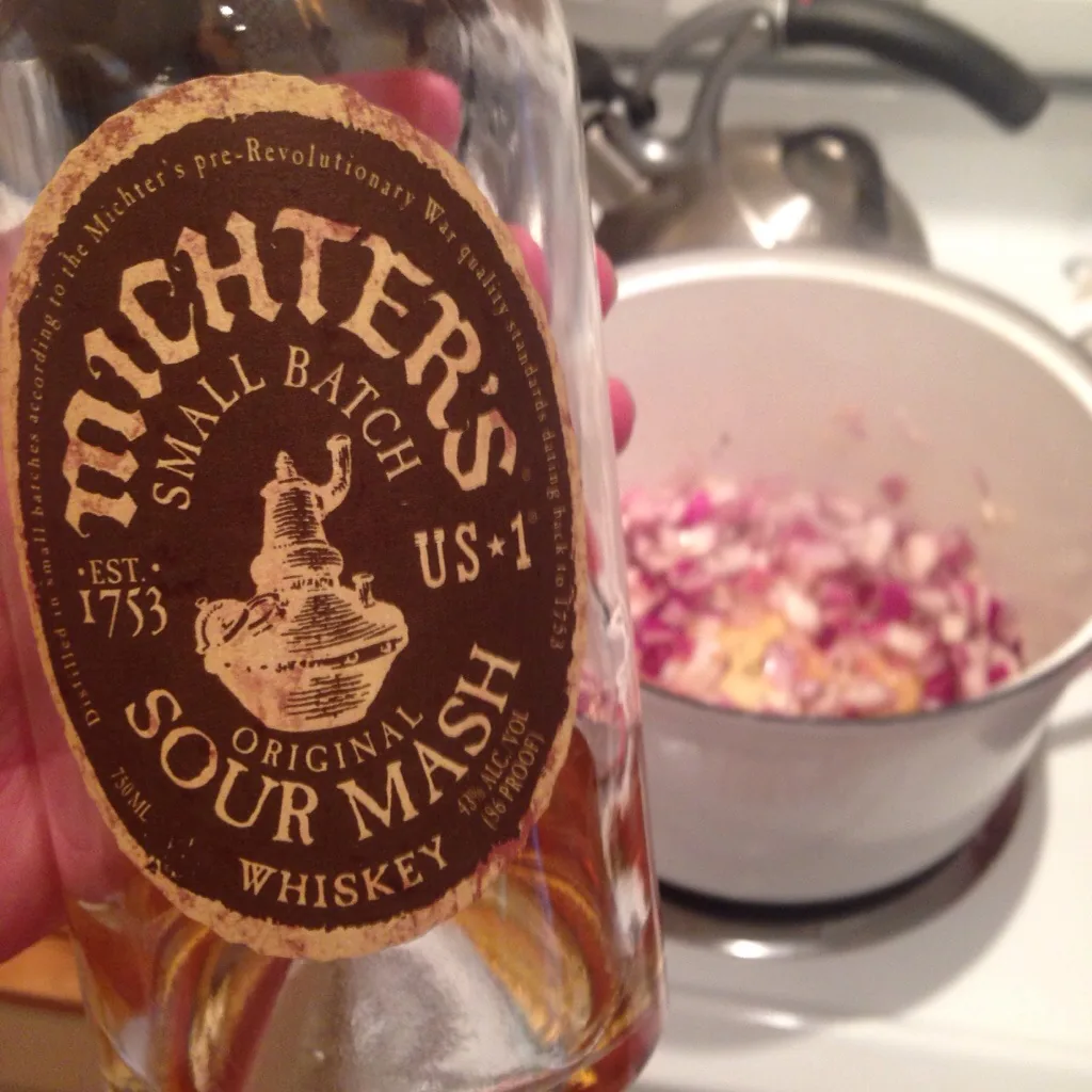 Michter's Small Batch and onions + garlic simmering in the Dutch oven